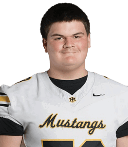 A person with short dark hair is wearing a white football jersey with “Mustangs" written on the front and smiling against a plain white background. Description generated by AI
