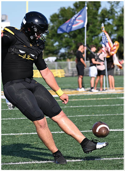 A football player wearing a blue and white uniform. Description generated by AI