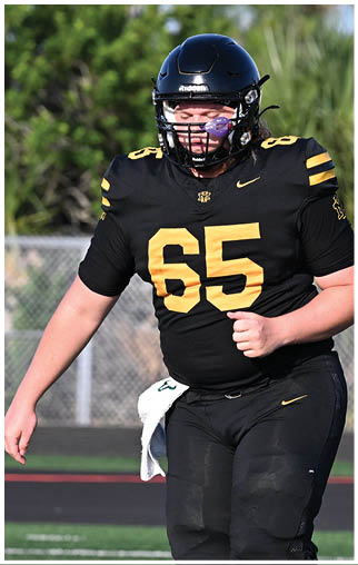 A football player running on the field. Description generated by AI