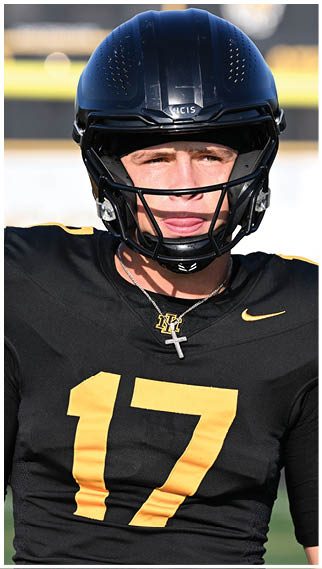 Two football players wearing blue and white uniforms. Description generated by AI