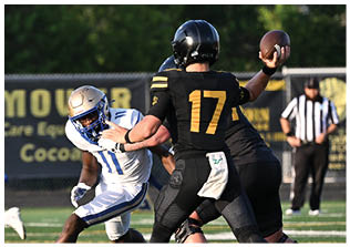 Two football players wearing blue and white uniforms. Description generated by AI