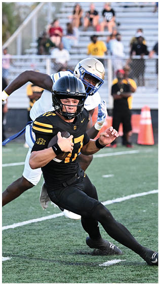 Two football players wearing blue and white uniforms. Description generated by AI