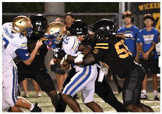 Two football players wearing blue and white uniforms. Description generated by AI