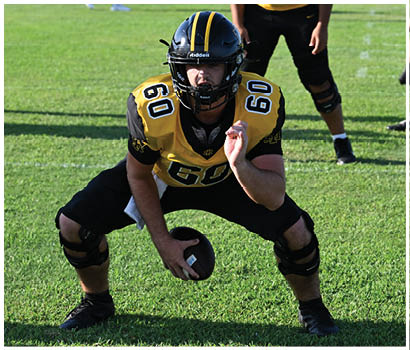 A group of football players on a field. Description generated by AI