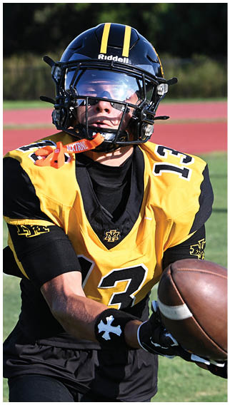 Two football players wearing blue and white uniforms. Description generated by AI