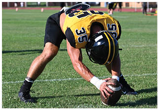 Two football players wearing blue and white uniforms. Description generated by AI