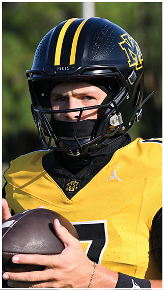Two football players wearing blue and white uniforms. Description generated by AI