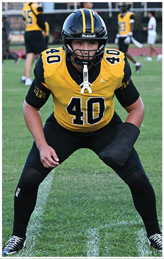 A football player running on the field. Description generated by AI