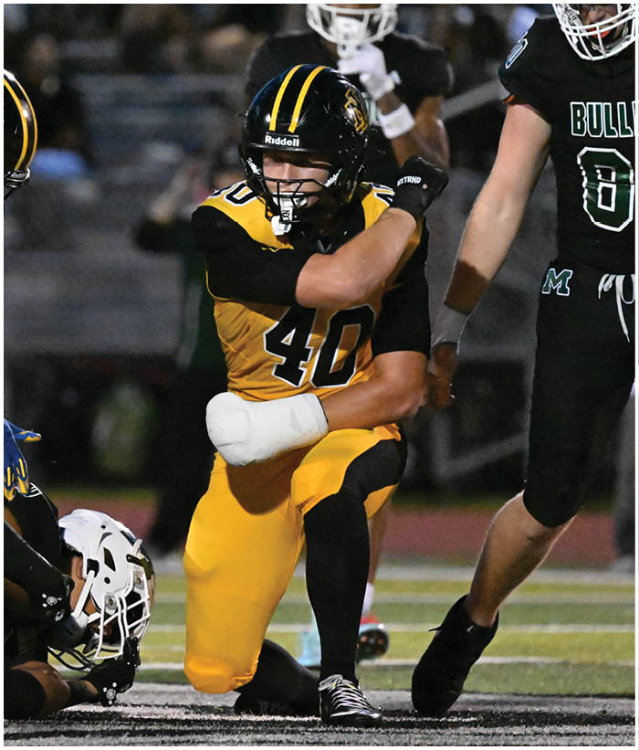 A group of football players wearing black and white uniforms. Description generated by AI