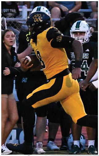 A football player running on the field. Description generated by AI