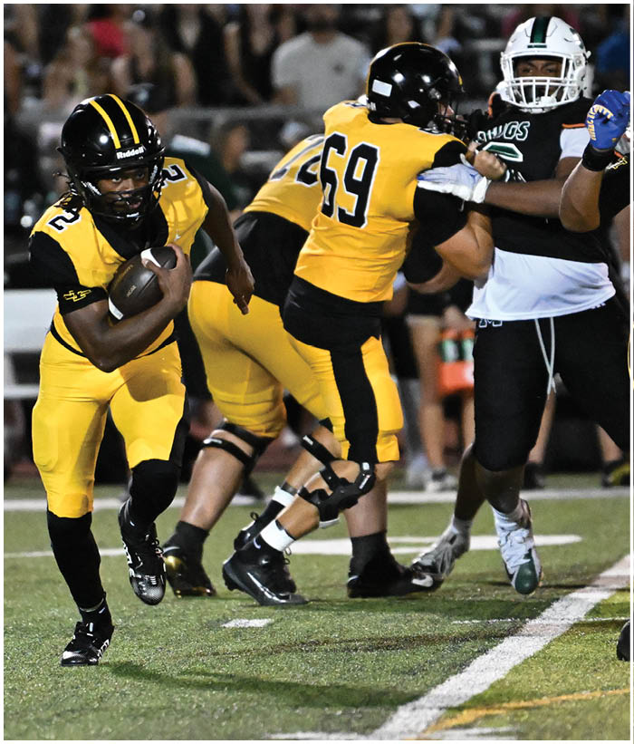 A group of football players wearing black and white uniforms. Description generated by AI