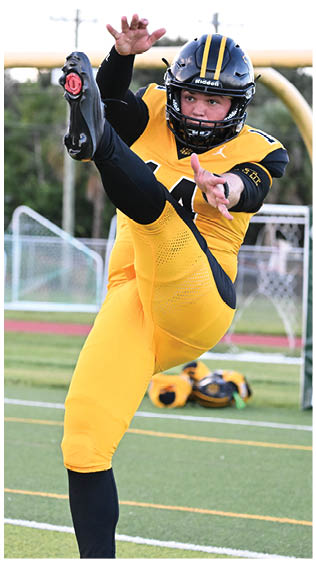 Two football players wearing blue and white uniforms. Description generated by AI