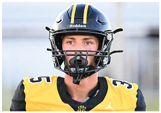Two football players wearing blue and white uniforms. Description generated by AI