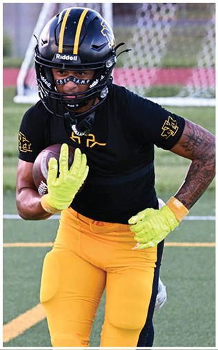 A football player running on the field. Description generated by AI