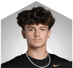A young man wearing a white jersey with the number 10 on it. Description generated by AI