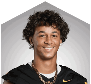 A young man wearing a white jersey with the number 10 on it. Description generated by AI