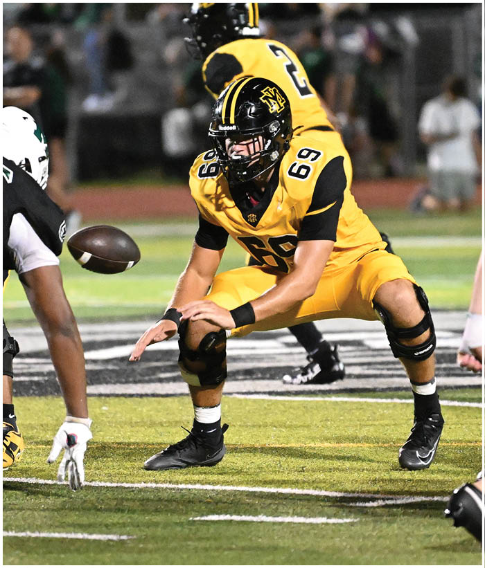 A group of football players wearing black and white uniforms. Description generated by AI