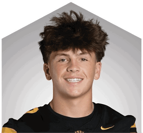 A young man wearing a white jersey with the number 10 on it. Description generated by AI