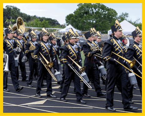 A man in a black jersey is running on a field with a football in his hand. AI generated content