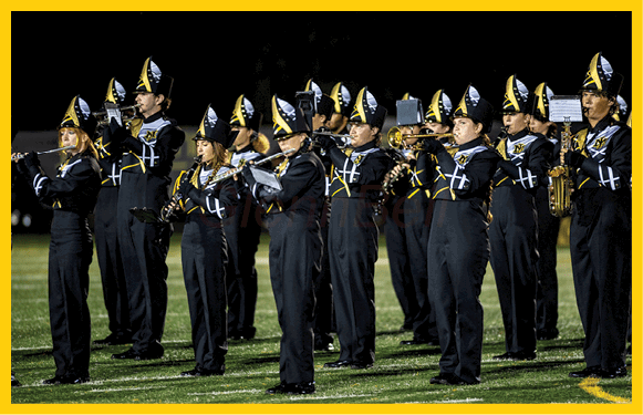 A group of people are kneeling on a field, possibly in a football game. AI generated content