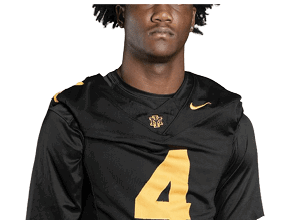 Person wearing a black sports jersey with a large yellow number four and a small logo on the chest. Description generated by AI