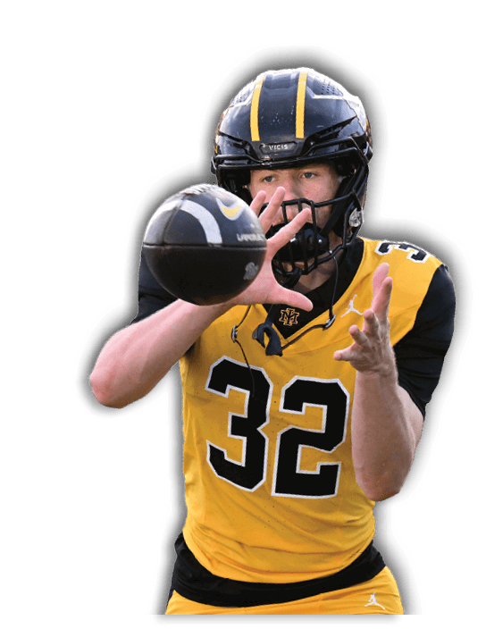 A person wearing a yellow and black football uniform with the number 32 is reaching out to catch a football. Description generated by AI