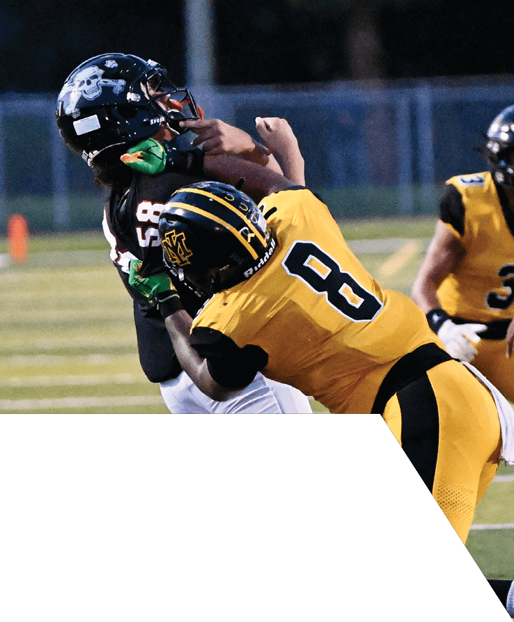 Two people wearing yellow and black sports uniforms are crouched on a football field preparing for a play. Description generated by AI