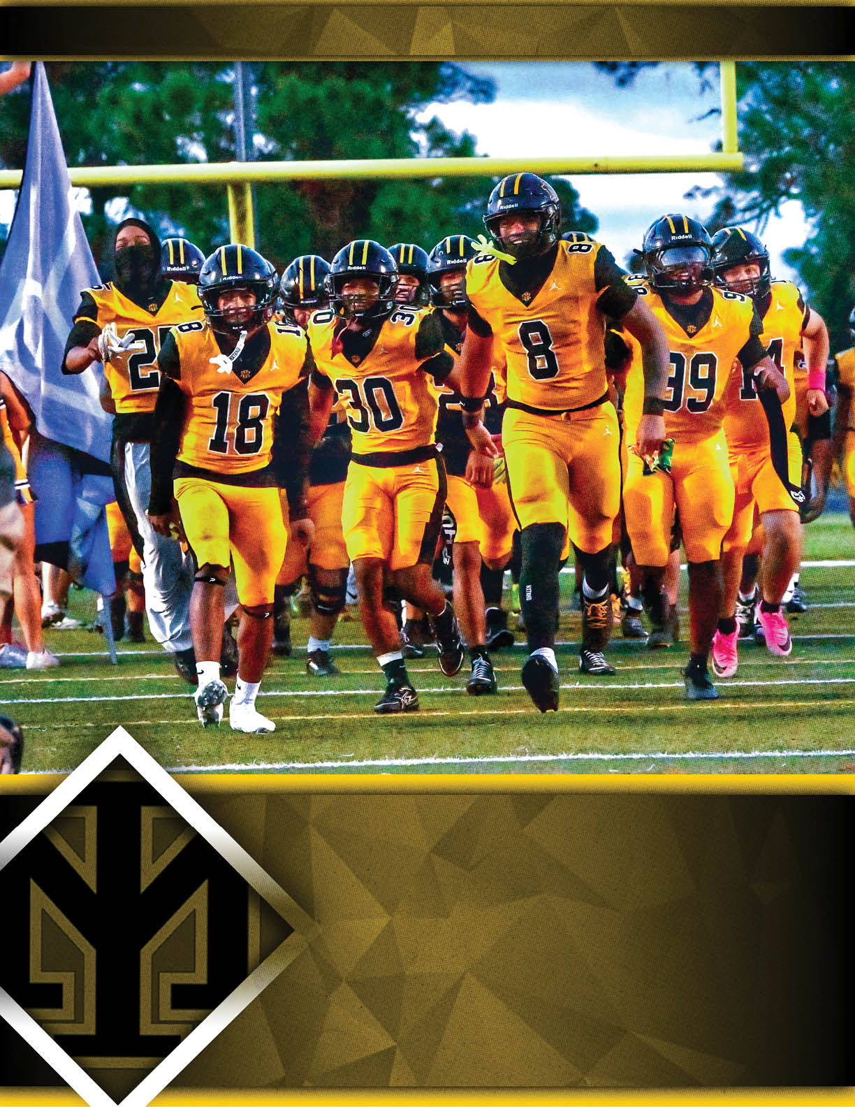 A group of people wearing yellow and black football uniforms are running together on a field with a goalpost and trees in the background. Description generated by AI