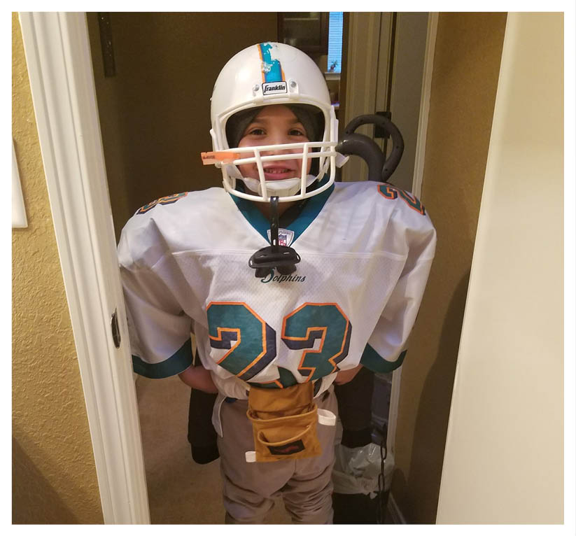 A football player wearing a blue and red jersey. Description generated by AI