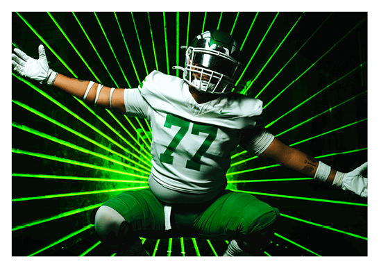 A football player wearing a blue and red jersey. Description generated by AI