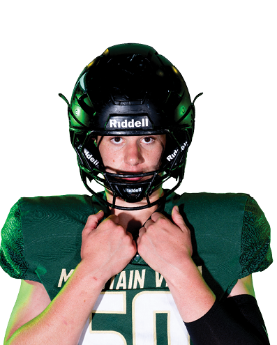 A person wearing a green football jersey with the number 50 and a black helmet is adjusting the helmet straps. Description generated by AI