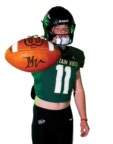 A person wearing a football helmet and uniform is holding a football extended toward the camera. Description generated by AI