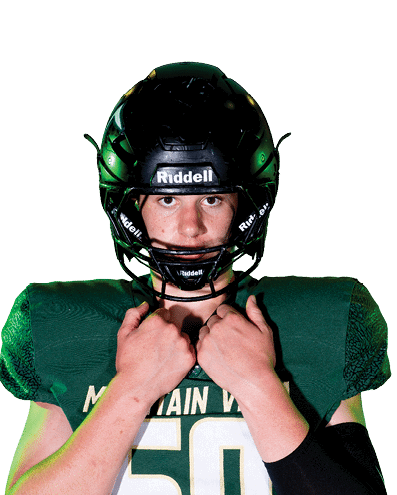 A person wearing a green football jersey with the number 50 and a black helmet is adjusting the helmet straps. Description generated by AI