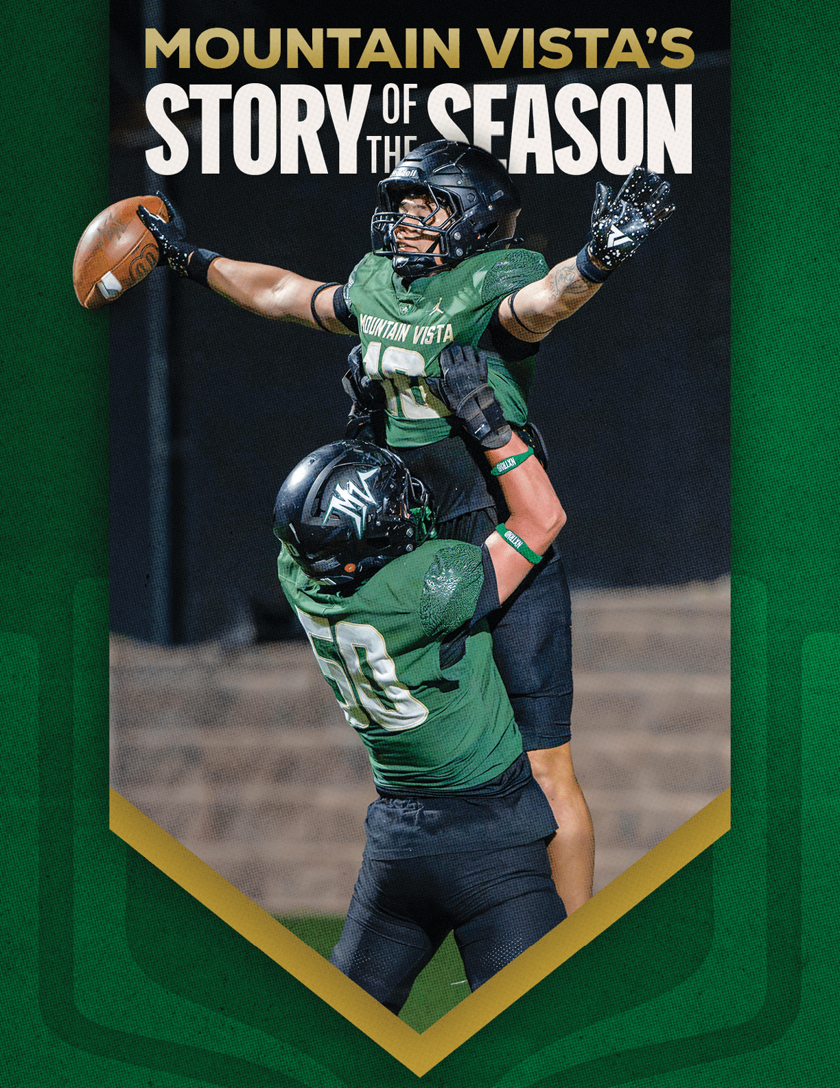 Two people in green football uniforms celebrate on a field with one person lifting the other who is holding a football. Description generated by AI
