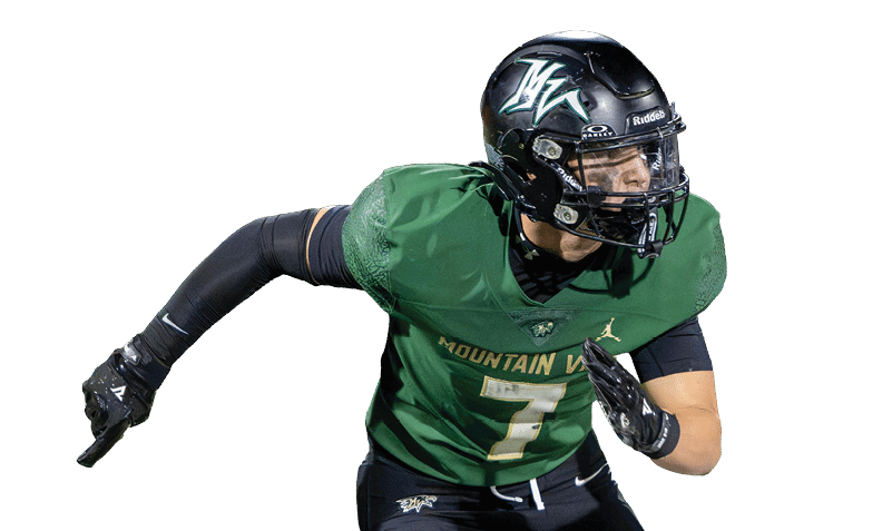 A person wearing a green football jersey and black helmet is running or preparing to make a move on a white background. Description generated by AI