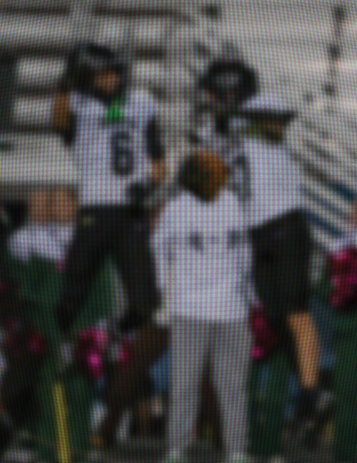 Three people wearing sports uniforms and helmets are standing on a field with one person in casual clothing in front of them. Description generated by AI