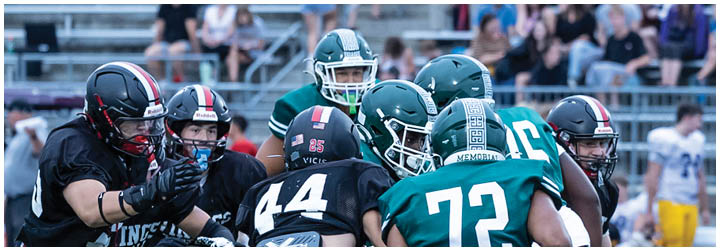 A football game is being played on a field with two teams. Description generated by AI