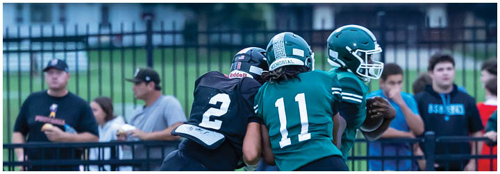 Two football players are fighting for a ball. Description generated by AI