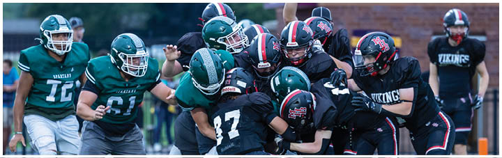 A group of football players on a field. Description generated by AI