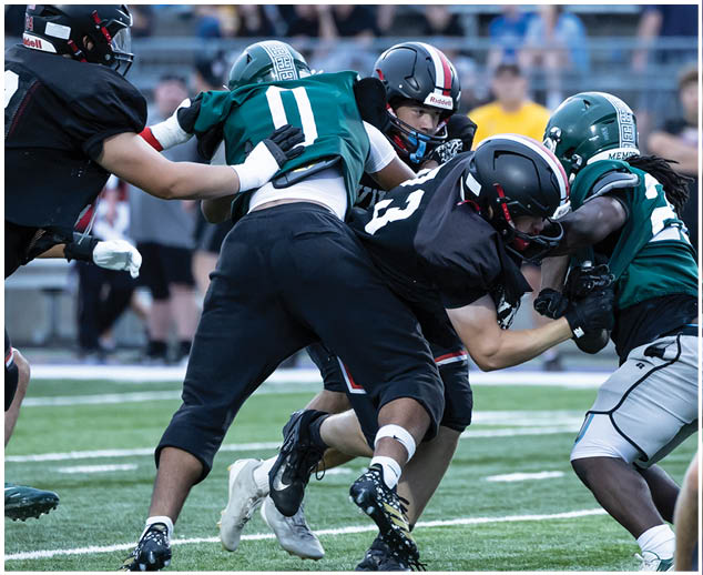 A group of football players on a field. Description generated by AI