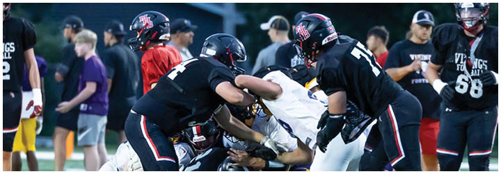 A group of football players on a field. Description generated by AI