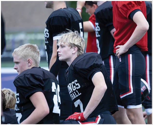 A football player wearing a black jersey with the number 7 on it. Description generated by AI