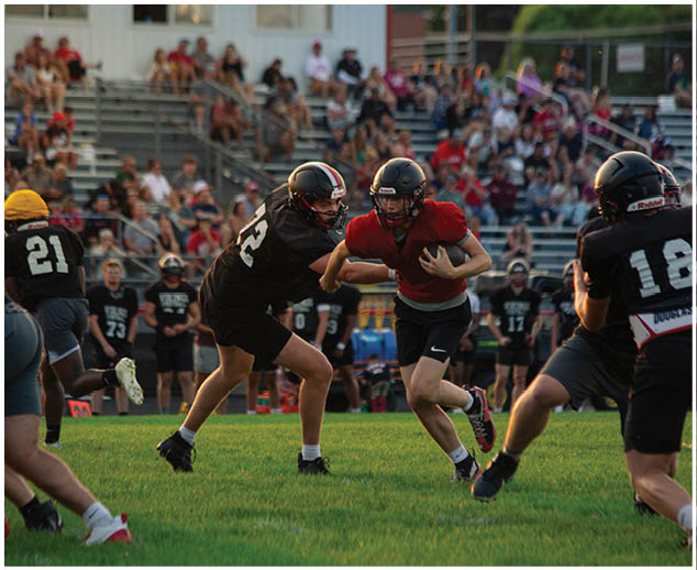 A group of football players on a field. Description generated by AI