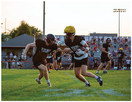 A football player running on the field. Description generated by AI