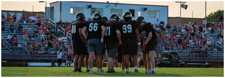 A group of football players on the field. Description generated by AI