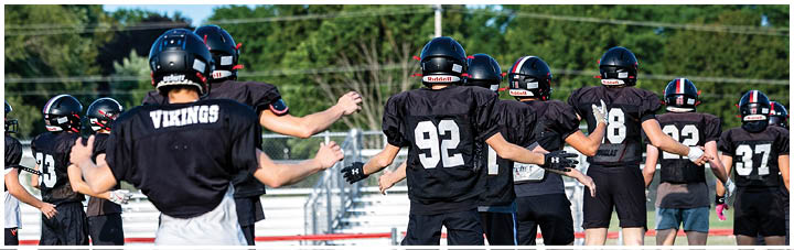 A group of football players on a field. Description generated by AI