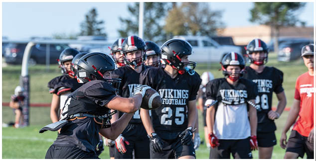 A football player wearing a black jersey with the number 25 on it. Description generated by AI