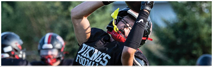 A football player catching a ball. Description generated by AI