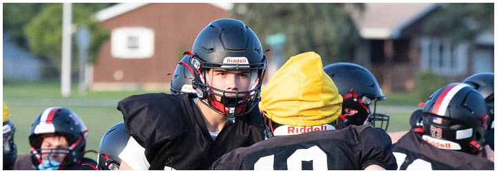 A group of football players on a field. Description generated by AI