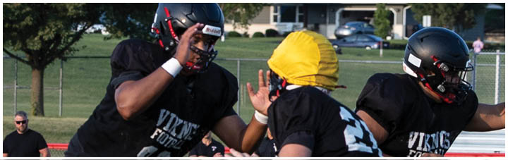 A football player in a black jersey with the number 19 on it. Description generated by AI